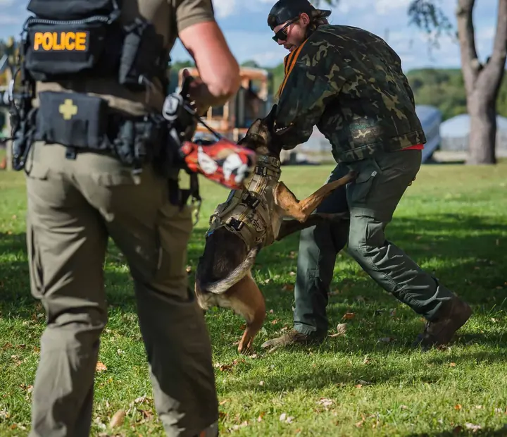 A police handler running his K9 on a decoy in the Christian K-9 Academy field